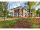 Two-story brown house with white columns and a landscaped yard at 903 W Franklin St, Monroe, NC 28112