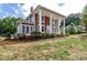 Side view of a charming two-story house with a landscaped yard at 903 W Franklin St, Monroe, NC 28112