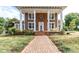 House exterior with columns, brick pathway, and porch swing at 903 W Franklin St, Monroe, NC 28112