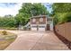 Two-car garage with spacious driveway and mature trees at 903 W Franklin St, Monroe, NC 28112