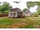 Backyard view of charming house with pergola and landscaping at 903 W Franklin St, Monroe, NC 28112