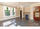 Living room with hardwood floors, fireplace, and stained glass windows at 903 W Franklin St, Monroe, NC 28112