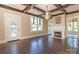 Living room with hardwood floors, fireplace, and decorative ceiling beams at 903 W Franklin St, Monroe, NC 28112