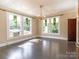 Spacious living room with hardwood floors, stained glass windows, and chandelier at 903 W Franklin St, Monroe, NC 28112