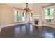 Living room with hardwood floors, fireplace, and stained glass windows at 903 W Franklin St, Monroe, NC 28112