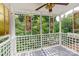 Screened porch overlooking lush garden with stained glass accents at 903 W Franklin St, Monroe, NC 28112