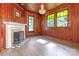 Cozy study with wood paneled walls, fireplace, and large windows at 903 W Franklin St, Monroe, NC 28112