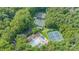 Aerial view of the community pool, clubhouse, tennis courts, and surrounding wooded area at 3020 Poplar Hill Rd, Charlotte, NC 28270