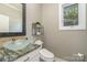 Modern bathroom with a clear glass bowl sink, bidet toilet, and sleek shelving, providing a stylish and functional space at 3020 Poplar Hill Rd, Charlotte, NC 28270