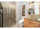 Bathroom with a walk-in shower, modern toilet, vanity with granite top, and decorative details at 3020 Poplar Hill Rd, Charlotte, NC 28270