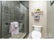Modern bathroom features a tiled shower with a glass enclosure and tiled walls at 3020 Poplar Hill Rd, Charlotte, NC 28270