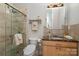 Bathroom with glass shower, marble countertop, and light wood vanity at 3020 Poplar Hill Rd, Charlotte, NC 28270
