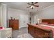 Spacious bedroom with dark wood furniture, a ceiling fan, and neutral walls at 3020 Poplar Hill Rd, Charlotte, NC 28270