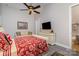 Comfortable bedroom features hardwood floors, a ceiling fan, and a sitting area at 3020 Poplar Hill Rd, Charlotte, NC 28270