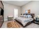 Bedroom features hardwood floors, soft blue bedding, and a modern aesthetic at 3020 Poplar Hill Rd, Charlotte, NC 28270