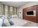 Spacious bedroom with TV, built-in storage, and patterned curtains at 3020 Poplar Hill Rd, Charlotte, NC 28270