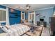 Stylish bedroom with a blue accent wall, decorative shelves, and a comfortable chair at 3020 Poplar Hill Rd, Charlotte, NC 28270