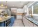 Modern kitchen with granite counters, island with seating, and stainless appliances at 3020 Poplar Hill Rd, Charlotte, NC 28270
