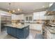 Modern kitchen with granite counters, island with seating, and stainless appliances at 3020 Poplar Hill Rd, Charlotte, NC 28270
