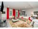 Open living room with large windows, bright red curtains, and a staircase in the background at 3020 Poplar Hill Rd, Charlotte, NC 28270