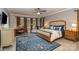 Comfortable main bedroom with a ceiling fan, large rug, and windows with stylish curtains at 3020 Poplar Hill Rd, Charlotte, NC 28270