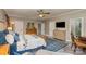 Spacious main bedroom featuring a ceiling fan, dresser, and wall-mounted television at 3020 Poplar Hill Rd, Charlotte, NC 28270