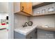 Charming wet bar with marble countertops, floating shelves, stainless steel kettle, and convenient access to the living area at 3020 Poplar Hill Rd, Charlotte, NC 28270