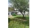 Backyard with patio, tree, and brick pathway at 4817 Mossy Cup Ln, Monroe, NC 28110