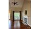 Spacious living room with hardwood floors, fireplace, and large window at 4817 Mossy Cup Ln, Monroe, NC 28110