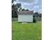 White storage shed with double doors in backyard at 4817 Mossy Cup Ln, Monroe, NC 28110