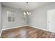 Bright dining room features hardwood floors and a stylish light fixture at 4819 Abercromby St, Charlotte, NC 28213