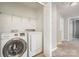 Laundry room with washer, dryer, and shelving at 4819 Abercromby St, Charlotte, NC 28213