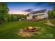 Expansive backyard with a fire pit and well-manicured lawn; ideal for outdoor activities at 127 Tradition Ln, Mooresville, NC 28115