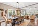 Open-concept dining area with a wooden table and view of a well-lit living room with hardwood floors at 127 Tradition Ln, Mooresville, NC 28115