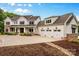Stunning two-story home with a three-car garage and manicured landscaping at 127 Tradition Ln, Mooresville, NC 28115