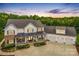 A sprawling two-story home with a three-car garage, and a covered front porch at 127 Tradition Ln, Mooresville, NC 28115
