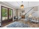 Elegant foyer with hardwood floors, staircase, bench, and natural light at 127 Tradition Ln, Mooresville, NC 28115