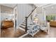 Inviting foyer featuring hardwood floors, staircase with white wainscotting, and stylish decor at 127 Tradition Ln, Mooresville, NC 28115