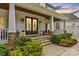 Inviting home entrance with double doors, stone accents, and manicured landscaping at 127 Tradition Ln, Mooresville, NC 28115