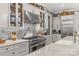 Well-lit kitchen featuring stainless steel appliances, white cabinetry, tile backsplash, and stone countertops at 127 Tradition Ln, Mooresville, NC 28115