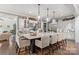 Modern kitchen with white cabinets, marble countertops, and large center island with seating at 127 Tradition Ln, Mooresville, NC 28115