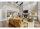 Open living space with a fireplace, TV, and comfortable couches overlooking the dining room at 127 Tradition Ln, Mooresville, NC 28115