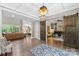 Open-concept living room with hardwood floors, and access to an office and kitchen at 127 Tradition Ln, Mooresville, NC 28115