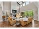 Spacious living room featuring a stone fireplace, TV, and comfortable couches at 127 Tradition Ln, Mooresville, NC 28115