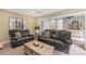 Comfortable living room featuring leather sofas, a wooden coffee table, and neutral decor at 127 Tradition Ln, Mooresville, NC 28115
