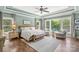 Spacious main bedroom with tray ceilings, hardwood floors, and large windows providing natural light at 127 Tradition Ln, Mooresville, NC 28115