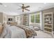 Sun-filled main bedroom featuring a ceiling fan, large windows, and a cozy seating area at 127 Tradition Ln, Mooresville, NC 28115