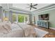 Well-lit main bedroom featuring hardwood floors, large windows, and a modern ceiling fan at 127 Tradition Ln, Mooresville, NC 28115