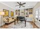 Cozy home office with custom built-in shelving, desk, and comfortable seating at 127 Tradition Ln, Mooresville, NC 28115