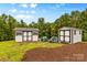 Two storage buildings with dark trim on a well-maintained, grassy lot at 127 Tradition Ln, Mooresville, NC 28115